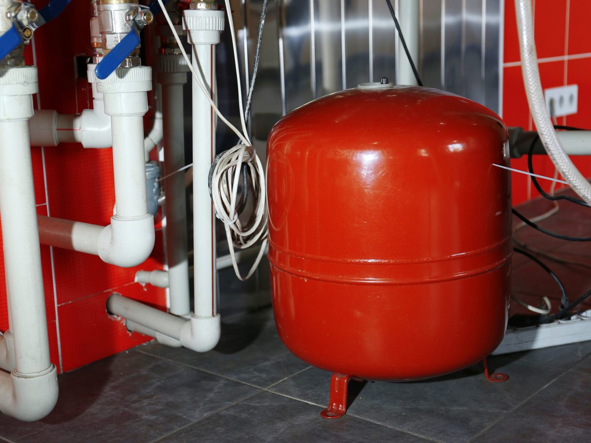 Boiler room with heating pipework and pressure gauges on the wall